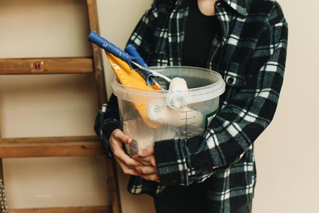 A Person Holding a Bucket