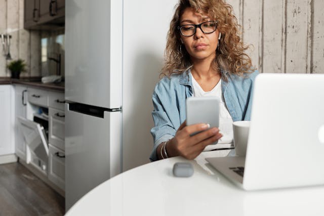 a tenant checking their texts at their kitchen table