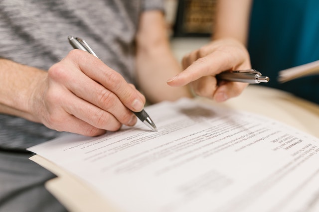 people reviewing and signing a lease contract